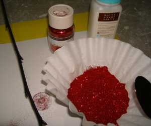 Gather glitter supplies.  I keep my glitter in a coffee filter so I can scoop it w a spoon & let the excess fall in the filter.  Or use a bog ol piece of paper for larger areas you plan to glitter.